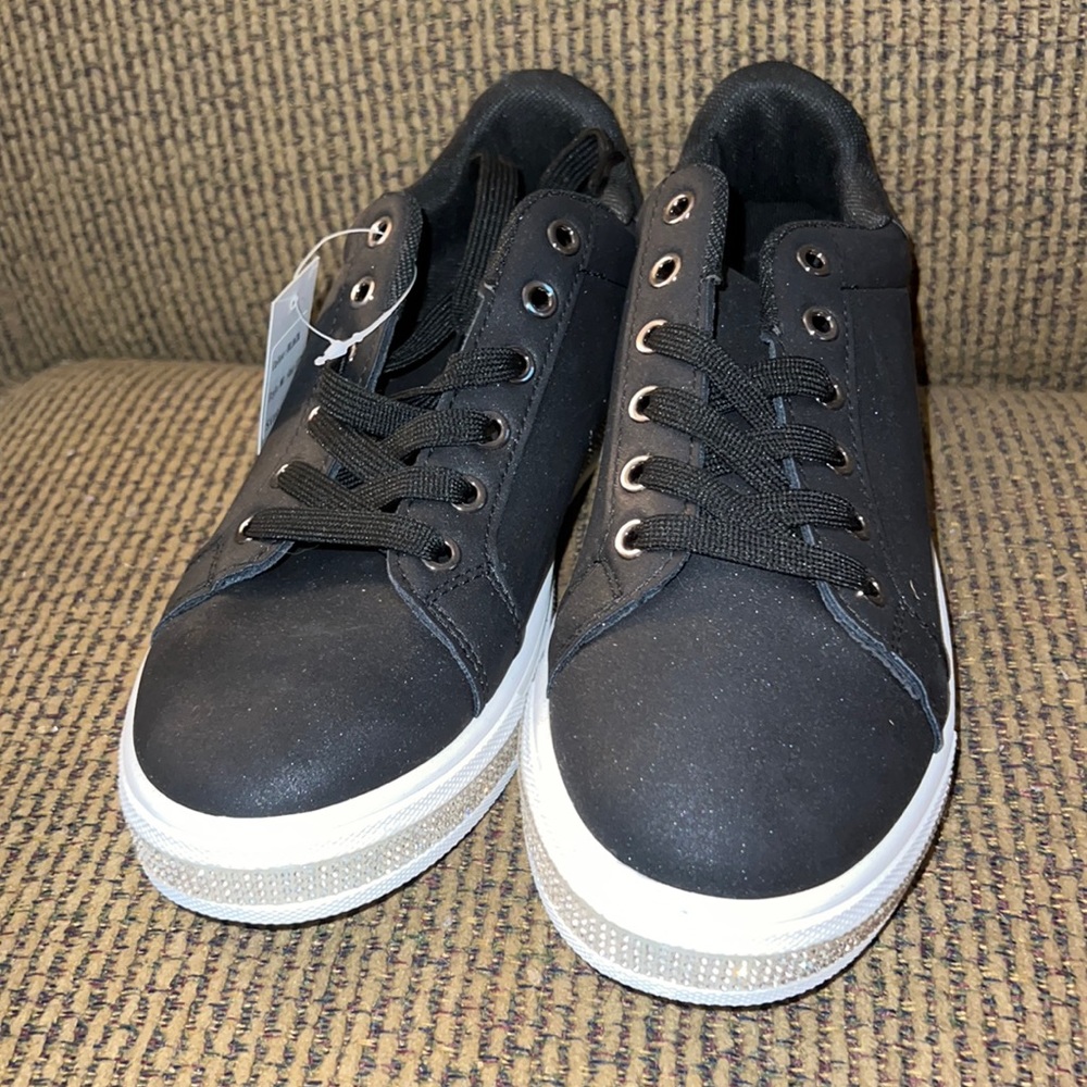 Brand new black tennis shoes with tags. Bedazzled around the soles.